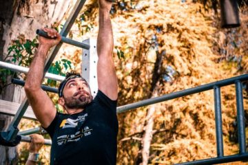 Homme au Tshirt noir suspendu à une échelle de singe